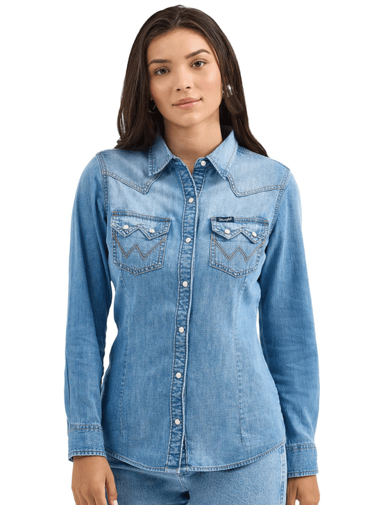 Wrangler 112367313 Womens Classic Denim Western Snap Shirt Blue front view. If you need any assistance with this item or the purchase of this item please call us at five six one seven four eight eight eight zero one Monday through Saturday 10:00a.m EST to 8:00 p.m EST