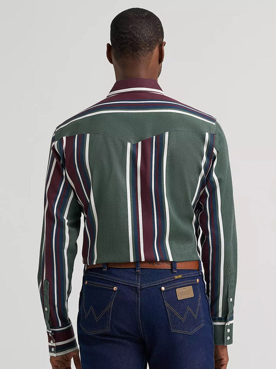 A man viewed from behind wearing a long-sleeve western-style shirt with green, burgundy, navy, and white vertical stripes, paired with dark blue jeans. If you need any assistance with this item or the purchase of this item please call us at five six one seven four eight eight eight zero one Monday through Saturday 10:00a.m EST to 8:00 p.m EST
