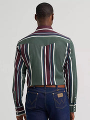A man viewed from behind wearing a long-sleeve western-style shirt with green, burgundy, navy, and white vertical stripes, paired with dark blue jeans. If you need any assistance with this item or the purchase of this item please call us at five six one seven four eight eight eight zero one Monday through Saturday 10:00a.m EST to 8:00 p.m EST