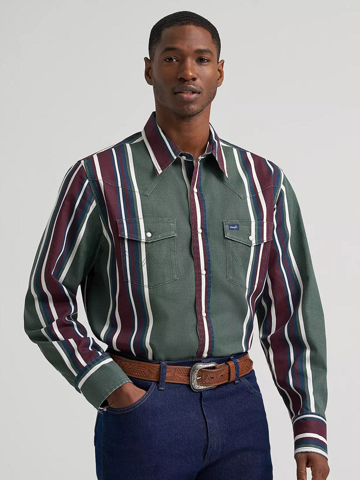 A man wearing a green western-style button-down shirt with vertical burgundy, white, and navy stripes, paired with a brown belt and dark blue jeans, against a light gray studio background. If you need any assistance with this item or the purchase of this item please call us at five six one seven four eight eight eight zero one Monday through Saturday 10:00a.m EST to 8:00 p.m EST