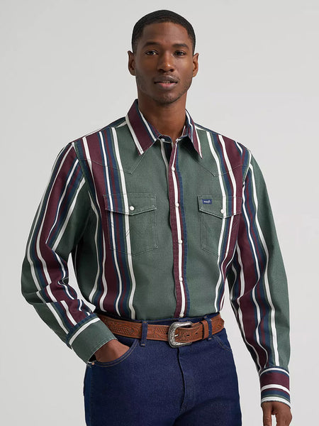 A man wearing a green western-style button-down shirt with vertical burgundy, white, and navy stripes, paired with a brown belt and dark blue jeans, against a light gray studio background. If you need any assistance with this item or the purchase of this item please call us at five six one seven four eight eight eight zero one Monday through Saturday 10:00a.m EST to 8:00 p.m EST