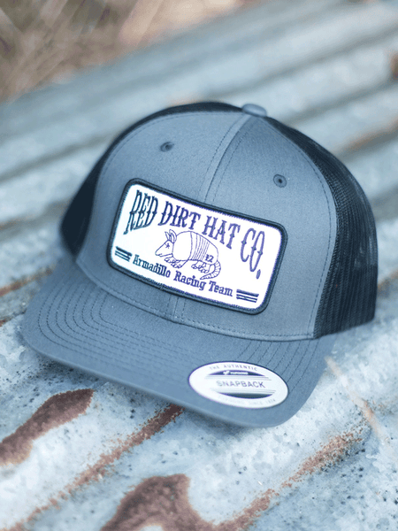 Red Dirt RDHC-101 ARMADILLO RACING TEAM Trucker Cap Black Charcoal front view. If you need any assistance with this item or the purchase of this item please call us at five six one seven four eight eight eight zero one Monday through Saturday 10:00a.m EST to 8:00 p.m EST