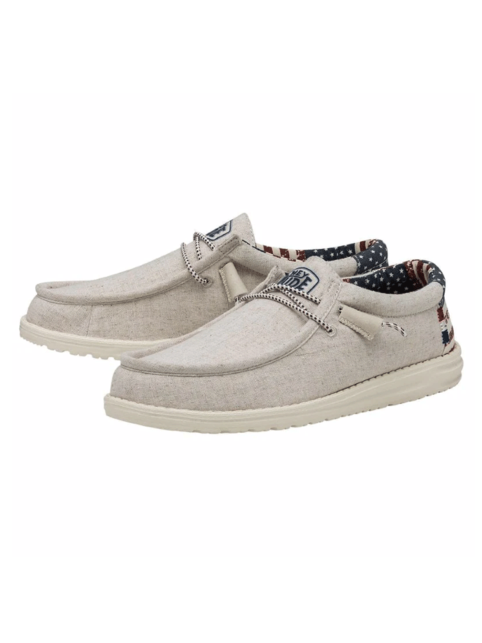Hey Dude 40001-1K1 Mens Wally Patriotic Shoe Off White front and side view. If you need any assistance with this item or the purchase of this item please call us at five six one seven four eight eight eight zero one Monday through Saturday 10:00a.m EST to 8:00 p.m EST