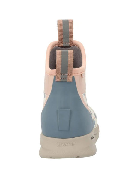 A single mid-top athletic shoe shown from the rear, featuring a dusty blue heel counter, a light pink collar, a beige pull tab, and a beige outsole, on a solid white background. If you need any assistance with this item or the purchase of this item please call us at five six one seven four eight eight eight zero one Monday through Saturday 10:00a.m EST to 8:00 p.m EST