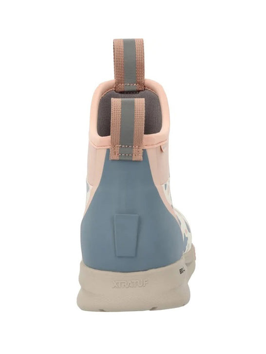 A single mid-top athletic shoe shown from the rear, featuring a dusty blue heel counter, a light pink collar, a beige pull tab, and a beige outsole, on a solid white background. If you need any assistance with this item or the purchase of this item please call us at five six one seven four eight eight eight zero one Monday through Saturday 10:00a.m EST to 8:00 p.m EST