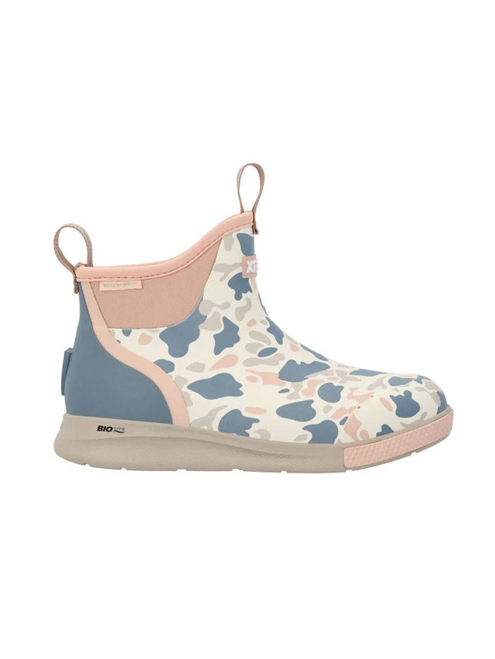 A single ankle-height slip-on boot with a pastel camouflage pattern in blue, pink, and cream, featuring a light pink collar, pull tabs, and sole, and a blue heel accent. If you need any assistance with this item or the purchase of this item please call us at five six one seven four eight eight eight zero one Monday through Saturday 10:00a.m EST to 8:00 p.m EST