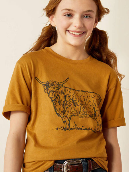 Ariat 10054022 Kids Highlander T-Shirt Harvest Gold close up. If you need any assistance with this item or the purchase of this item please call us at five six one seven four eight eight eight zero one Monday through Saturday 10:00a.m EST to 8:00 p.m EST