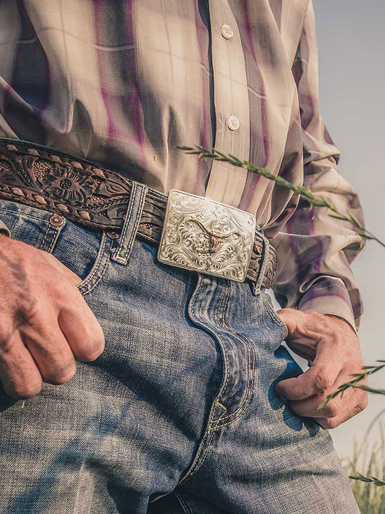 Montana Silversmiths 46510-64 Iconic Western Longhorn Belt Buckle Silver on model. If you need any assistance with this item or the purchase of this item please call us at five six one seven four eight eight eight zero one Monday through Saturday 10:00a.m EST to 8:00 p.m EST