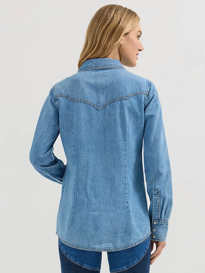 Wrangler 112360616 Womens X Lainey Wilson Moxie Western Denim Shirt Mid Wash Light Blue front view. If you need any assistance with this item or the purchase of this item please call us at five six one seven four eight eight eight zero one Monday through Saturday 10:00a.m EST to 8:00 p.m EST

