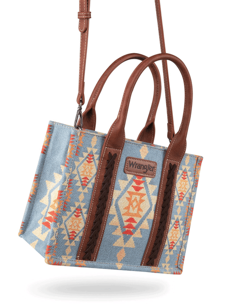 Wrangler WG2202-8120SBR Womens Southwestern Print Small Canvas Crossbody Tote Brown Light Blue hanging view. If you need any assistance with this item or the purchase of this item please call us at five six one seven four eight eight eight zero one Monday through Saturday 10:00a.m EST to 8:00 p.m EST

