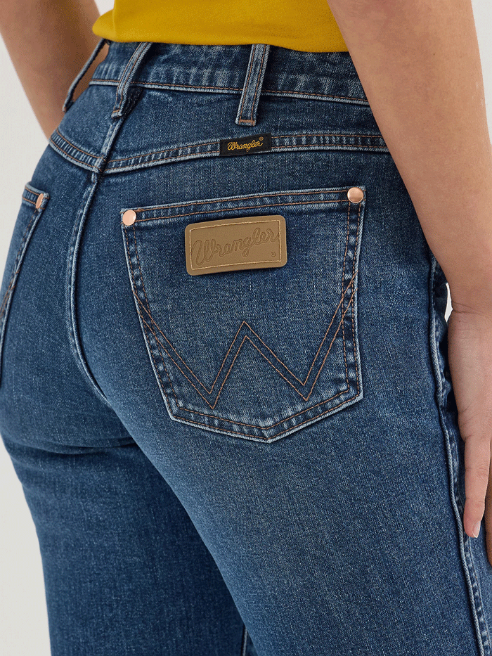 Wrangler 112360638 Womens X Lainey Wilson Bell Bottoms Jeans Baskin Blue Wash front. If you need any assistance with this item or the purchase of this item please call us at five six one seven four eight eight eight zero one Monday through Saturday 10:00a.m EST to 8:00 p.m EST

