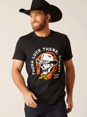 Ariat 10047839 Unisex Sendero Winking Skull T-Shirt Black front view on male model. If you need any assistance with this item or the purchase of this item please call us at five six one seven four eight eight eight zero one Monday through Saturday 10:00a.m EST to 8:00 p.m EST