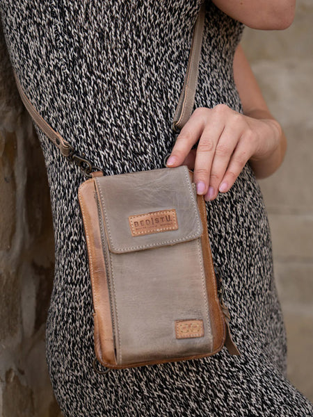 Bed Stu A450319-OTICRS-X Womens Alelike Essentials Crossbody Bag Oats Icicle Rustic front view on model.If you need any assistance with this item or the purchase of this item please call us at five six one seven four eight eight eight zero one Monday through Saturday 10:00a.m EST to 8:00 p.m EST