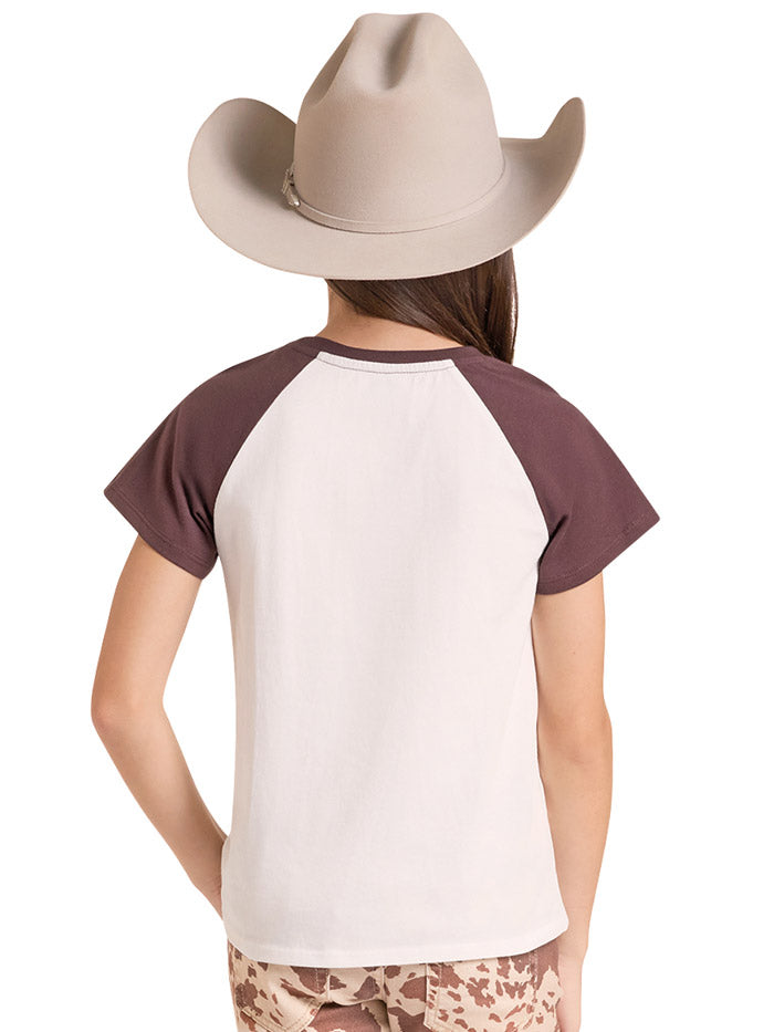 A smiling girl wearing a beige cowboy hat and a raglan-style t-shirt with a brown graphic of a horse and the words Cowgirl. If you need any assistance with this item or the purchase of this item please call us at five six one seven four eight eight eight zero one Monday through Saturday 10:00a.m EST to 8:00 p.m EST