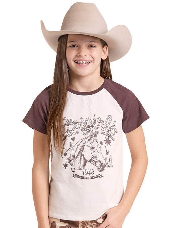 A smiling girl wearing a beige cowboy hat and a raglan-style t-shirt with a brown graphic of a horse and the words Cowgirl. If you need any assistance with this item or the purchase of this item please call us at five six one seven four eight eight eight zero one Monday through Saturday 10:00a.m EST to 8:00 p.m EST