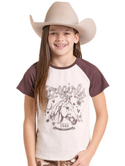 A smiling girl wearing a beige cowboy hat and a raglan-style t-shirt with a brown graphic of a horse and the words Cowgirl. If you need any assistance with this item or the purchase of this item please call us at five six one seven four eight eight eight zero one Monday through Saturday 10:00a.m EST to 8:00 p.m EST