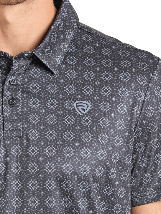 Close-up of a patterned shirt with a brand logo on a white background. If you need any assistance with this item or the purchase of this item please call us at five six one seven four eight eight eight zero one Monday through Saturday 10:00a.m EST to 8:00 p.m EST