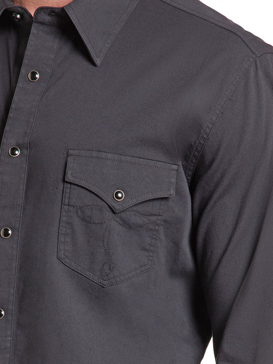 Close-up of a black long-sleeve button-down shirt with a chest pocket and metal snap buttons. If you need any assistance with this item or the purchase of this item please call us at five six one seven four eight eight eight zero one Monday through Saturday 10:00a.m EST to 8:00 p.m EST
