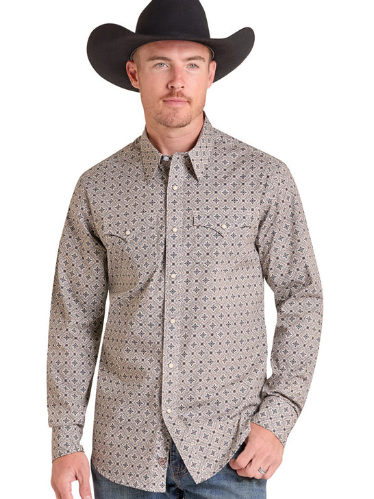 A man wearing a black cowboy hat and a long-sleeve western button-up shirt with a small geometric pattern in beige, gray, and black, paired with blue jeans against a white background. If you need any assistance with this item or the purchase of this item please call us at five six one seven four eight eight eight zero one Monday through Saturday 10:00a.m EST to 8:00 p.m EST