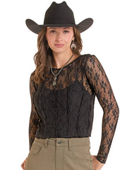 A woman wearing a black long-sleeve lace top with sheer sleeves, a black cowboy hat, and khaki pants, photographed against a plain white background. If you need any assistance with this item or the purchase of this item please call us at five six one seven four eight eight eight zero one Monday through Saturday 10:00a.m EST to 8:00 p.m EST