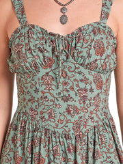 Close-up of a sleeveless dress with a ruffled sweetheart neckline and thin shoulder straps, featuring an all-over paisley and floral print in sage green, rust red, and dark brown on a white background. If you need any assistance with this item or the purchase of this item please call us at five six one seven four eight eight eight zero one Monday through Saturday 10:00a.m EST to 8:00 p.m EST