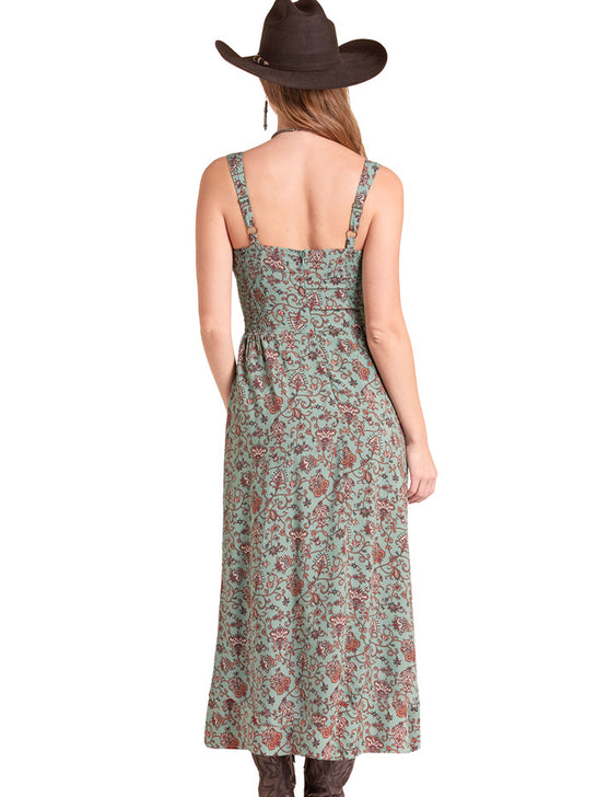 A woman shown from the back wearing a sleeveless midi dress with a green and rust floral pattern, a brown cowboy hat, and brown boots against a plain white background. If you need any assistance with this item or the purchase of this item please call us at five six one seven four eight eight eight zero one Monday through Saturday 10:00a.m EST to 8:00 p.m EST