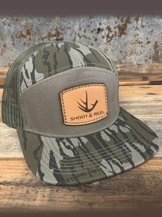 Shoot & Reel SR9-MOBG Antler Patch Flat Bill Cap Mossy Oak Bottomland Gator side / front view. If you need any assistance with this item or the purchase of this item please call us at five six one seven four eight eight eight zero one Monday through Saturday 10:00a.m EST to 8:00 p.m EST