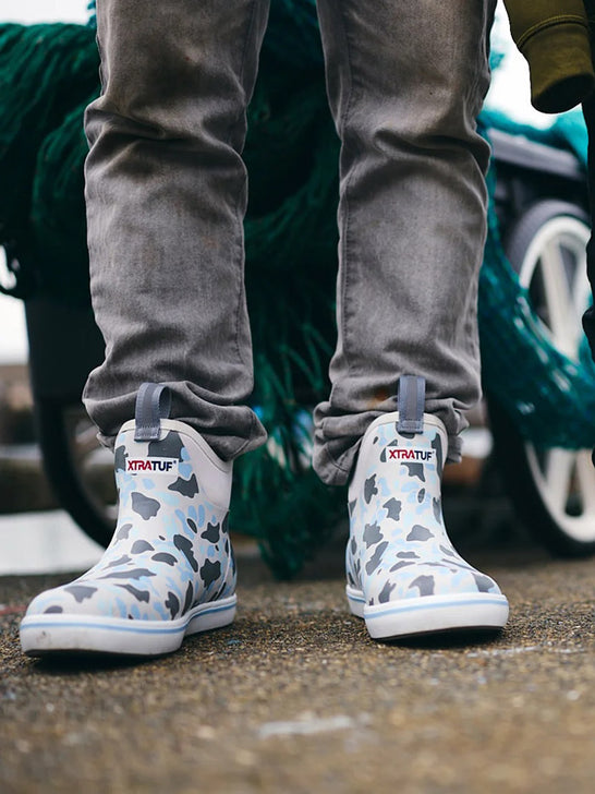 Xtratuf XMABDCI Mens Ankle Deck Boot Ice Duck Camo view on model. If you need any assistance with this item or the purchase of this item please call us at five six one seven four eight eight eight zero one Monday through Saturday 10:00a.m EST to 8:00 p.m EST