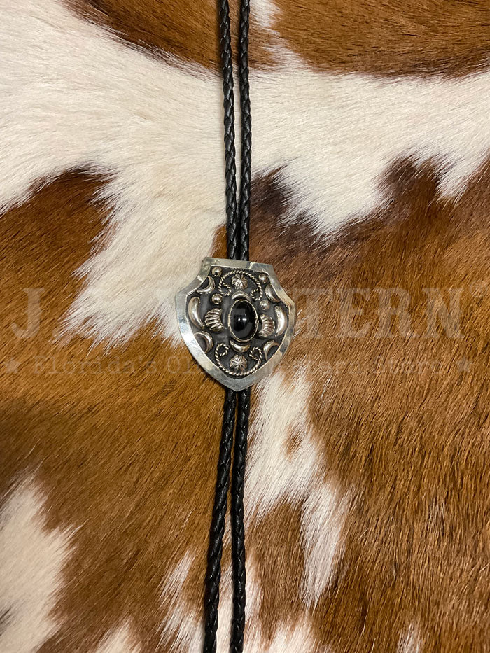 Fashionwest AC58B Small Oval Stone Western Bolo Tie Black close up. If you need any assistance with this item or the purchase of this item please call us at five six one seven four eight eight eight zero one Monday through Saturday 10:00a.m EST to 8:00 p.m EST