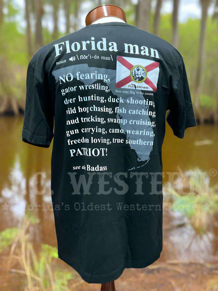 FloGrown FGM-1785 Mens Florida Man Definition Tee Black back view. If you need any assistance with this item or the purchase of this item please call us at five six one seven four eight eight eight zero one Monday through Saturday 10:00a.m EST to 8:00 p.m EST 