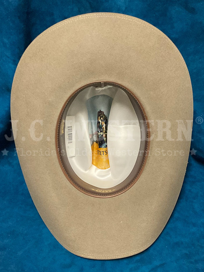 Stetson SFTRGY-754220 TRILOGY 6X Western Hat Stone side front view. If you need any assistance with this item or the purchase of this item please call us at five six one seven four eight eight eight zero one Monday through Saturday 10:00a.m EST to 8:00 p.m EST