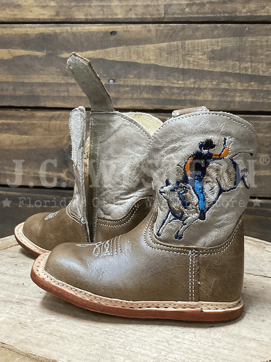Roper 09-016-7912-8801 Infants Cowbabies Bull Rider Boot Tan velcro side and bull rider side view. If you need any assistance with this item or the purchase of this item please call us at five six one seven four eight eight eight zero one Monday through Saturday 10:00a.m EST to 8:00 p.m EST