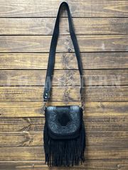 Trinity Ranch TR187-8360BK Womens Genuine Hair On Cowhide Tooled Fringe Crossbody Bag Black front view hanging. If you need any assistance with this item or the purchase of this item please call us at five six one seven four eight eight eight zero one Monday through Saturday 10:00a.m EST to 8:00 p.m EST