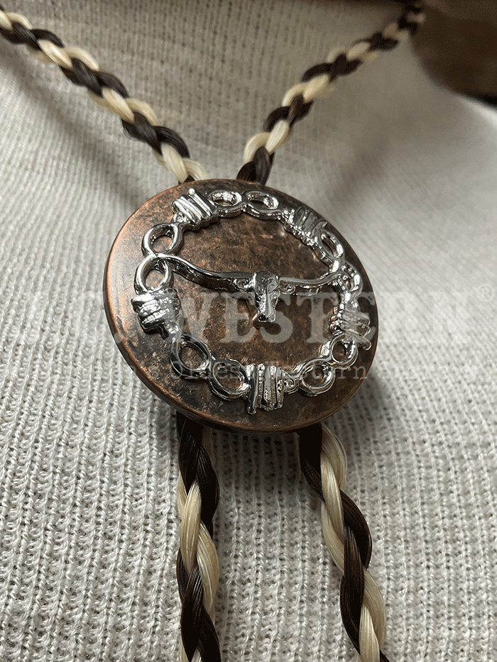 Cowboy Collectibles BOLT506 The Longhorn Bolo Tie Creme And Dark Sorrel close up. If you need any assistance with this item or the purchase of this item please call us at five six one seven four eight eight eight zero one Monday through Saturday 10:00a.m EST to 8:00 p.m EST