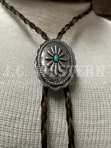 Cowboy Collectibles BOLT513 Iconic Turquoise Bolo Tie Granite And Black close up. If you need any assistance with this item or the purchase of this item please call us at five six one seven four eight eight eight zero one Monday through Saturday 10:00a.m EST to 8:00 p.m EST