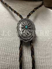 Cowboy Collectibles BOLT513 Iconic Turquoise Bolo Tie Granite And Black close up. If you need any assistance with this item or the purchase of this item please call us at five six one seven four eight eight eight zero one Monday through Saturday 10:00a.m EST to 8:00 p.m EST