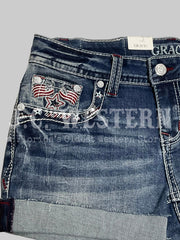 Grace in LA JHW62055 Womens America Flap Low Rise Shorts Denim front close up. If you need any assistance with this item or the purchase of this item please call us at five six one seven four eight eight eight zero one Monday through Saturday 10:00a.m EST to 8:00 p.m EST
