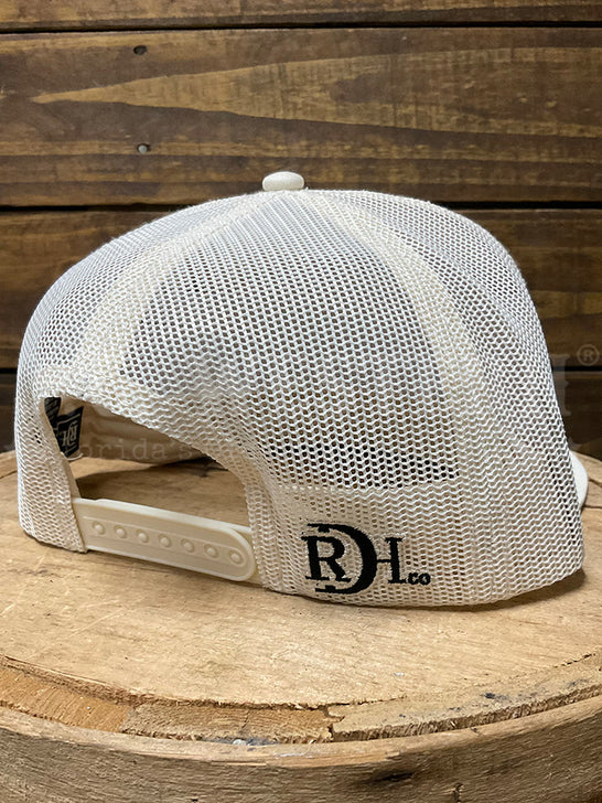 A white mesh trucker cap with a black 'RD L co.' logo on the side, displayed on a rustic wooden stump against a dark wood plank background.If you need any assistance with this item or the purchase of this item please call us at five six one seven four eight eight eight zero one Monday through Saturday 10:00a.m EST to 8:00 p.m EST