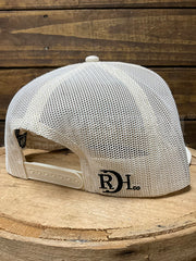 A white mesh trucker cap with a black 'RD L co.' logo on the side, displayed on a rustic wooden stump against a dark wood plank background.If you need any assistance with this item or the purchase of this item please call us at five six one seven four eight eight eight zero one Monday through Saturday 10:00a.m EST to 8:00 p.m EST