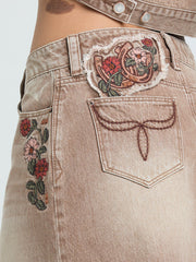 Grace In LA JKW-S913 Womens Floral Embroidered Denim Skirt Camel Tan back side close up. If you need any assistance with this item or the purchase of this item please call us at five six one seven four eight eight eight zero one Monday through Saturday 10:00a.m EST to 8:00 p.m EST
