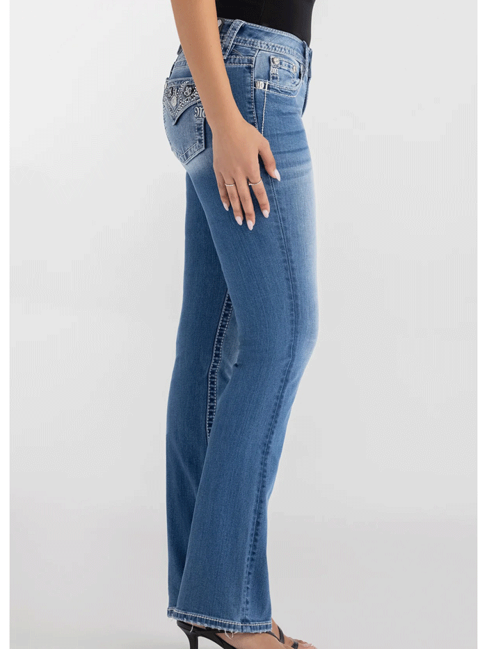 Miss Me M9498BL Womens Solene Fleur Mid Rise Bootcut Jean Medium Blue back close up view. If you need any assistance with this item or the purchase of this item please call us at five six one seven four eight eight eight zero one Monday through Saturday 10:00a.m EST to 8:00 p.m EST
