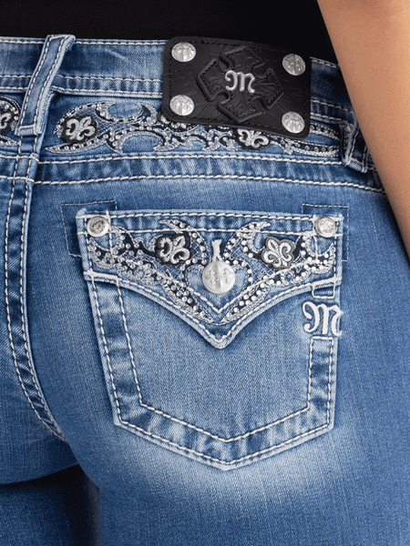Miss Me M9498BL Womens Solene Fleur Mid Rise Bootcut Jean Medium Blue back close up view. If you need any assistance with this item or the purchase of this item please call us at five six one seven four eight eight eight zero one Monday through Saturday 10:00a.m EST to 8:00 p.m EST
