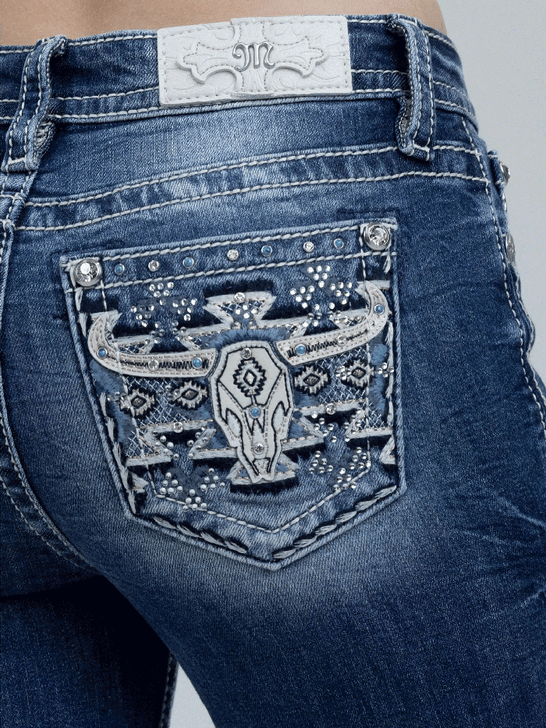 Miss Me M9600BV Womens Mid Rise Slim Fit Bootcut Jean Medium Blue back close up. If you need any assistance with this item or the purchase of this item please call us at five six one seven four eight eight eight zero one Monday through Saturday 10:00a.m EST to 8:00 p.m EST