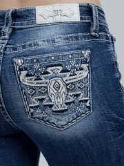 Miss Me M9600BV Womens Mid Rise Slim Fit Bootcut Jean Medium Blue back close up. If you need any assistance with this item or the purchase of this item please call us at five six one seven four eight eight eight zero one Monday through Saturday 10:00a.m EST to 8:00 p.m EST