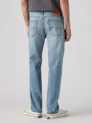A person shown from the back wearing light-wash blue jeans, a dark gray t-shirt, and white low-top sneakers against a light gray studio background. If you need any assistance with this item or the purchase of this item please call us at five six one seven four eight eight eight zero one Monday through Saturday 10:00a.m EST to 8:00 p.m EST
