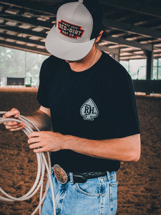 Red Dirt RDHC-T-173 Mens Hold ‘Em Tee Black front view. If you need any assistance with this item or the purchase of this item please call us at five six one seven four eight eight eight zero one Monday through Saturday 10:00a.m EST to 8:00 p.m EST