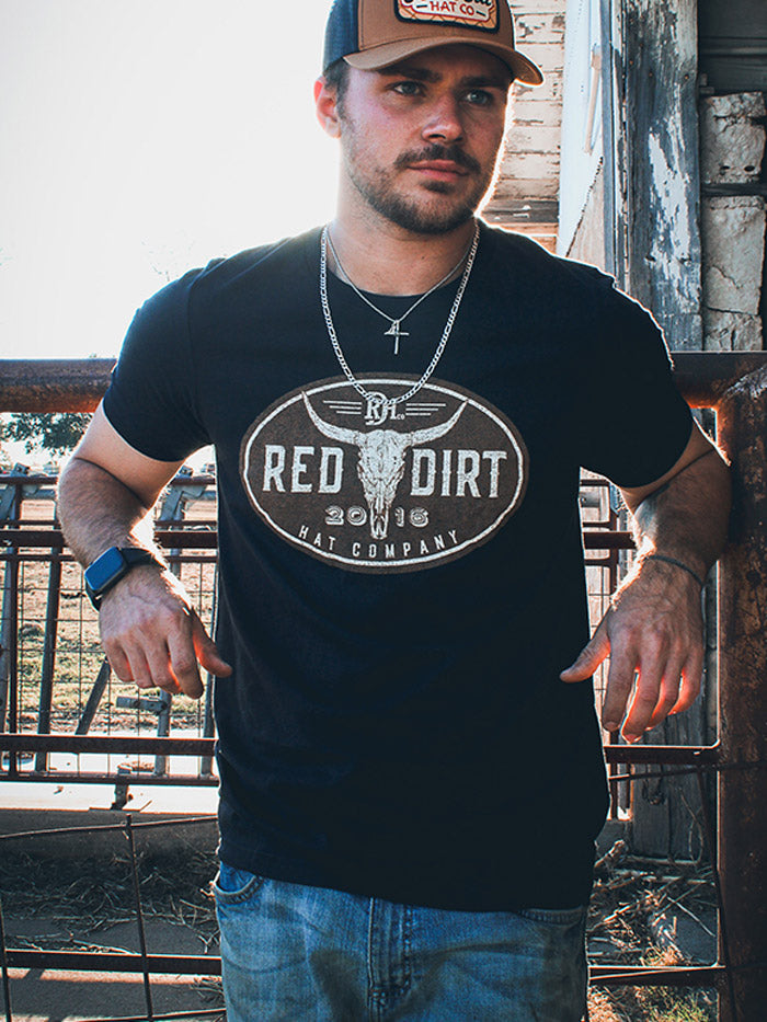 Red Dirt RDHC-T-195 Mens Steer Clear Tee Black front view on model. If you need any assistance with this item or the purchase of this item please call us at five six one seven four eight eight eight zero one Monday through Saturday 10:00a.m EST to 8:00 p.m EST