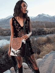 Myra Bag S-6769 Womens Ritzy Rift Hand Tooled Bag Black on model. If you need any assistance with this item or the purchase of this item please call us at five six one seven four eight eight eight zero one Monday through Saturday 10:00a.m EST to 8:00 p.m EST