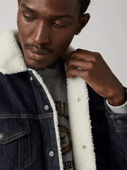 Levis 163650285 Mens Type III Sherpa Trucker Jacket Inse It Out Sherpa Blue close up. If you need any assistance with this item or the purchase of this item please call us at five six one seven four eight eight eight zero one Monday through Saturday 10:00a.m EST to 8:00 p.m EST