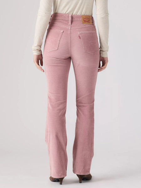 A person shown from the back wearing pink corduroy jeans with a cream long-sleeve top and dark brown heels, photographed against a light gray studio background. If you need any assistance with this item or the purchase of this item please call us at five six one seven four eight eight eight zero one Monday through Saturday 10:00a.m EST to 8:00 p.m EST